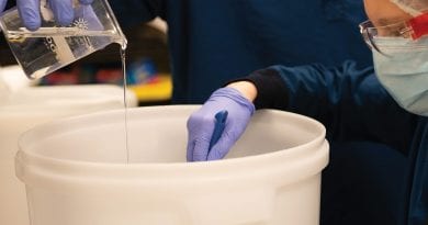 Theory Wellness staff make hand sanitizer