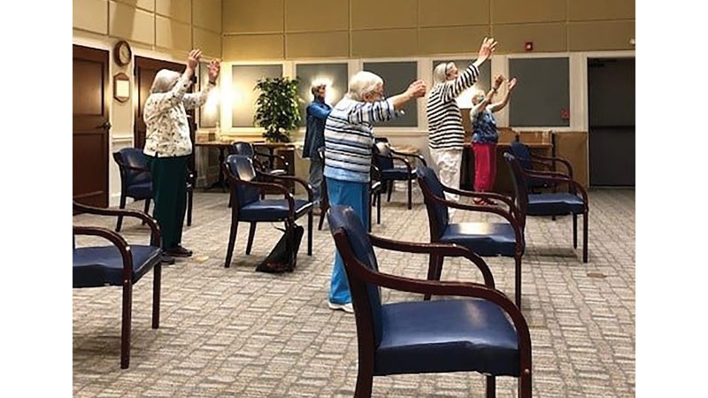 Residents at Kimball Farms engage in tai chi.