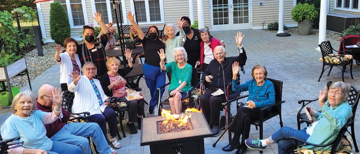 Residents enjoy some social time outside an Arbors facility.