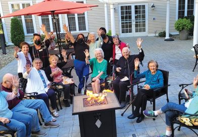 Residents enjoy some social time outside an Arbors facility.